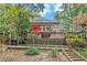 Backyard view of a home's deck, landscaping, and stairway at 7740 Sagebrush Dr, Atlanta, GA 30350