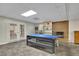 Recreational basement space featuring a ping pong table and brick fireplace at 7740 Sagebrush Dr, Atlanta, GA 30350