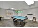 Basement game room features a pool table with overhead lighting and new flooring at 7740 Sagebrush Dr, Atlanta, GA 30350