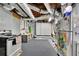 View of the basement space including workspace, shelving and visible ventilation and an older stove and refrigerator at 7740 Sagebrush Dr, Atlanta, GA 30350
