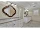 Elegant bathroom features dual vanities with granite countertops, designer mirrors and tiled flooring at 7740 Sagebrush Dr, Atlanta, GA 30350
