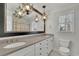 Elegant bathroom featuring a double vanity, chandelier, and a large mirror at 7740 Sagebrush Dr, Atlanta, GA 30350
