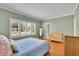 Serene bedroom with hardwood floors, large windows with plantation shutters, and bench seat at 7740 Sagebrush Dr, Atlanta, GA 30350