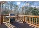 Deck with grill overlooks wooded backyard in this home for sale at 7740 Sagebrush Dr, Atlanta, GA 30350
