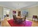 Spacious dining room with hardwood floors, chandelier, and large window overlooking backyard at 7740 Sagebrush Dr, Atlanta, GA 30350