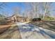 Exterior front of house featuring large driveway, landscaping, and mature trees at 7740 Sagebrush Dr, Atlanta, GA 30350