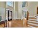 Bright and welcoming foyer with hardwood floors and a decorative front door at 7740 Sagebrush Dr, Atlanta, GA 30350