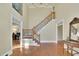 Elegant foyer with hardwood floors, staircase with iron railings, and natural light at 7740 Sagebrush Dr, Atlanta, GA 30350