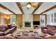 Cozy living room with exposed wood ceiling beams, fireplace, and comfortable seating at 7740 Sagebrush Dr, Atlanta, GA 30350