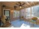 Screened-in patio with brick surround, ceiling fan, and comfortable wicker seating at 7740 Sagebrush Dr, Atlanta, GA 30350