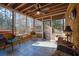 Screened-in patio with brick surround, ceiling fan, wicker seating, and wooded views at 7740 Sagebrush Dr, Atlanta, GA 30350