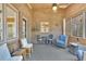 Spacious porch features brick wall, comfortable seating, curtains and ceiling fan, offering perfect outdoor space at 7740 Sagebrush Dr, Atlanta, GA 30350