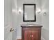 Elegant powder room features a dark wood vanity with granite countertop and decorative mirror at 7740 Sagebrush Dr, Atlanta, GA 30350