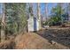 Photo of a small storage shed in a wooded area of the property at 7740 Sagebrush Dr, Atlanta, GA 30350