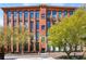 Charming brick building with large windows, lush trees, and manicured landscaping at 170 Boulevard Se # E127, Atlanta, GA 30312