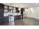 Modern kitchen featuring stainless steel appliances, dark wood cabinets, and drop lighting at 170 Boulevard Se # E127, Atlanta, GA 30312