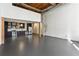 Open floor plan featuring a modern kitchen, spiral staircase, and exposed wooden beams at 170 Boulevard Se # E127, Atlanta, GA 30312