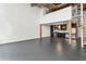 Open floor plan with a modern kitchen, spiral staircase, and wooden support beams at 170 Boulevard Se # E127, Atlanta, GA 30312