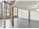 Bright living room with large windows, exposed brick walls, and modern gray flooring at 170 Boulevard Se # E127, Atlanta, GA 30312