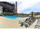 Inviting community pool with lounge chairs, mature landscaping, and a unique industrial backdrop at 170 Boulevard Se # E127, Atlanta, GA 30312