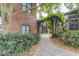 Charming walkway with lush landscaping, brick walls, and a wooden pergola at 170 Boulevard Se # E127, Atlanta, GA 30312