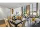 Open living space featuring spiral staircase, dining area, and views of exposed brick walls and large windows at 170 Boulevard Se # E127, Atlanta, GA 30312