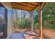 Back porch with wood columns and wood flooring with a scenic view of the wooded back yard at 189 Privet Cir, Suwanee, GA 30024