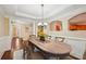 Formal dining room featuring an oval table, a chandelier, and wood floors at 189 Privet Cir, Suwanee, GA 30024