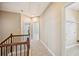 Carpeted hallway with wood railing, neutral walls, and views of adjacent rooms at 189 Privet Cir, Suwanee, GA 30024