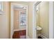 Hallway featuring hardwood floors, leading to a door and a powder room with pedestal sink at 189 Privet Cir, Suwanee, GA 30024