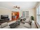 Cozy living room with plush seating, a ceiling fan, and a view of the open kitchen at 189 Privet Cir, Suwanee, GA 30024