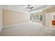 This spacious main bedroom features a tray ceiling, multiple windows, and plush carpeting at 189 Privet Cir, Suwanee, GA 30024