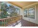 Charming covered porch with wooden floors and railing, offering a serene outdoor space at 189 Privet Cir, Suwanee, GA 30024