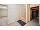 Unfinished basement stairwell leading to an open space with stairs and a black mat at 189 Privet Cir, Suwanee, GA 30024