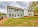 Back exterior of home with siding, windows, a sliding glass door, and a grassy yard at 2955 Jefferson St, Austell, GA 30106