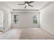 Spacious bedroom featuring a ceiling fan, two windows, and neutral carpet at 2955 Jefferson St, Austell, GA 30106