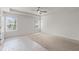 Spacious bedroom featuring a ceiling fan, two windows, and neutral carpet at 2955 Jefferson St, Austell, GA 30106