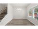 Bright dining room with a modern chandelier, large window, and wood-look flooring at 2955 Jefferson St, Austell, GA 30106