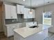 Modern kitchen with white cabinets, a center island, and stainless steel appliances at 2955 Jefferson St, Austell, GA 30106