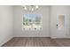 Bright living room featuring wood-look flooring, large window, and a white doorway at 2955 Jefferson St, Austell, GA 30106