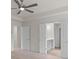 Main bedroom with ceiling fan and ensuite bathroom access through double doors at 2955 Jefferson St, Austell, GA 30106