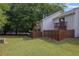 Large grassy backyard with wooden fence, mature trees and balcony at 6 Nw Fairway Nw Dr, Kennesaw, GA 30144