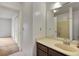 Bathroom with a wooden vanity, cream countertops, and large mirror, creating a calm atmosphere at 6 Nw Fairway Nw Dr, Kennesaw, GA 30144