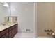 Bathroom with a wooden vanity, cream countertops, and large mirror, creating a calm atmosphere at 6 Nw Fairway Nw Dr, Kennesaw, GA 30144