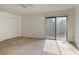 Large primary bedroom featuring neutral carpet, a ceiling fan and natural light from sliding glass doors at 6 Nw Fairway Nw Dr, Kennesaw, GA 30144