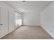 Sunlit bedroom featuring soft carpet, a large window with blinds, and fresh white walls creating a serene space at 6 Nw Fairway Nw Dr, Kennesaw, GA 30144
