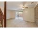 Inviting living room with brick accent wall, plush carpeting, and sliding glass doors to the patio at 6 Nw Fairway Nw Dr, Kennesaw, GA 30144