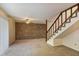 Spacious living area features a brick wall accent, carpet flooring and stairs to the second floor at 6 Nw Fairway Nw Dr, Kennesaw, GA 30144