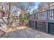View of the backyard with a gated driveway, deck with railing and lattice, and a privacy fence at 1069 Colquitt Ne Ave, Atlanta, GA 30307