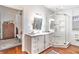 Bright bathroom featuring a walk-in shower, dual sink vanity, and modern fixtures at 1069 Colquitt Ne Ave, Atlanta, GA 30307
